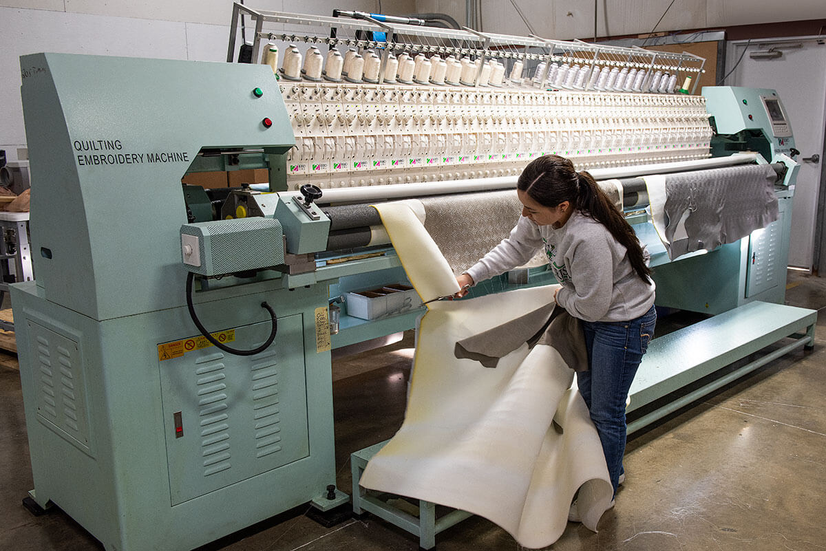 Williamsburg Marine Embroidery Machine with Worker Cutting Fabric